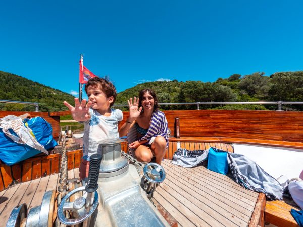 A family on the excursion boat cruise around the island of Ithaki or Ithaca in the Ionian sea